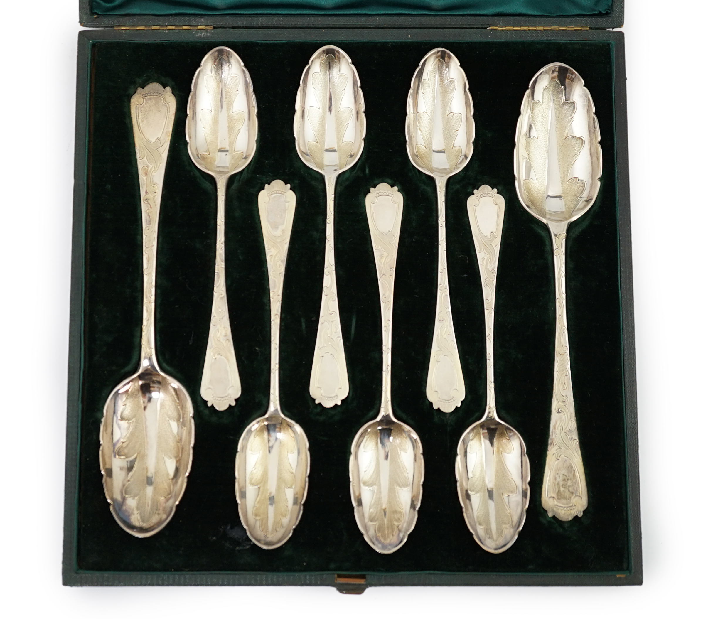 A Victorian cased set of six engraved silver dessert spoons and two serving spoons, by George Adams